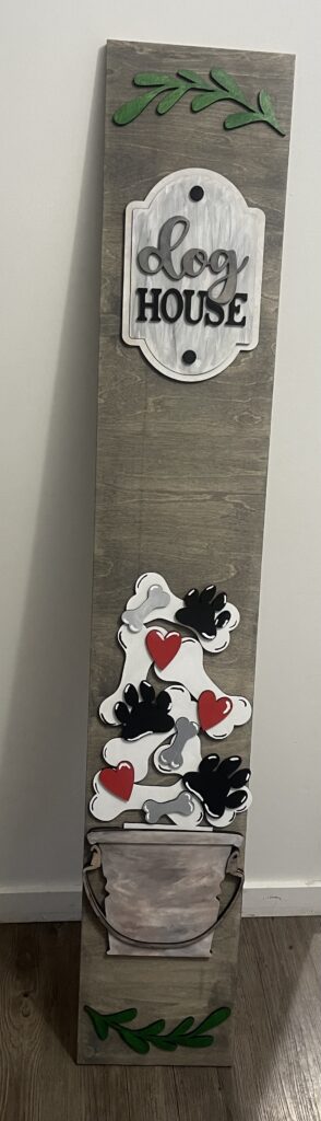 wooden porch leaner sign with dog house, bones, paws, and heart shapes